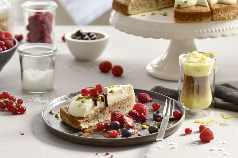 Banana Walnut Barista Cake with chocolate sauce and berries
